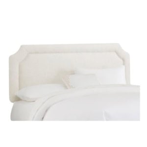 Upholstered bed featuring a light-colored, rectangular headboard and crisp white bedding offers a serene and Lily look for less, set against a plain white background.
