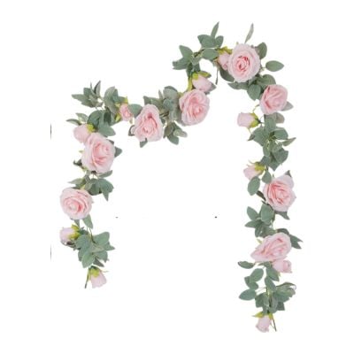 A charming LoveShackFancy look for less, this pink rose garland with green leaves is artfully arranged in an arch on a pristine white background.