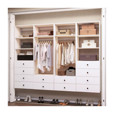 A neatly organized kids' closet with hanging clothes, boxed items on shelves, drawers for small accessories, and tiny shoes lined up at the bottom.