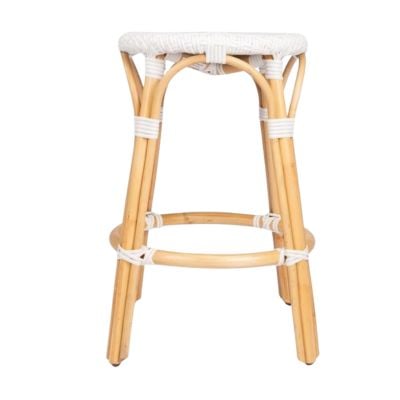 A light-colored rattan bar stool with four legs, white woven seat, and white binding on the joints offers a chic Serena and Lily look for less.