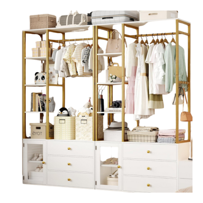 Open kids closet with clothes, bags, and storage boxes. White shelves and drawers hold folded items and decor. Hanging garments include dresses and shirts. Accessories are neatly organized for easy access.