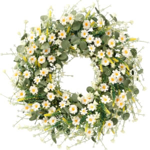 A spring wreath made of green leaves and white flowers, beautifully arranged in a circular pattern.