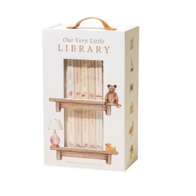A boxed set of children's books titled "Our Very Little Library," featuring illustrated shelves, a teddy bear, and a lamp on the packaging. The box has a handle on top—perfect as delightful Easter basket fillers.