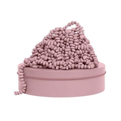 A round, pale pink box with a pile of small, pink bean-shaped objects arranged on top and spilling over the side—perfect as charming Easter basket fillers.