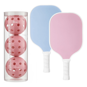 Two pickleball paddles, one blue and one pink, are displayed next to a clear tube containing three pink pickleballs—perfect as Easter basket fillers for active kids or sports enthusiasts.
