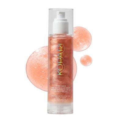 A clear pump bottle of Kopari Rose Gold Sun Shield Body Glow SPF 50 with pink shimmering product inside—perfect for Easter basket fillers—with radiant product swatches in the background.