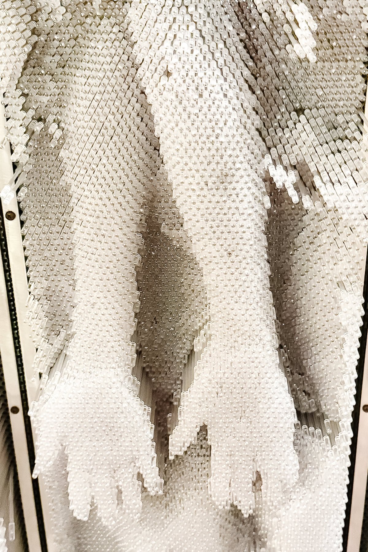 A close-up view of two hand impressions made in a bed of vertical plastic pins, like those found in sensory pin art toys—a fun activity often featured among the things to do in Branson.