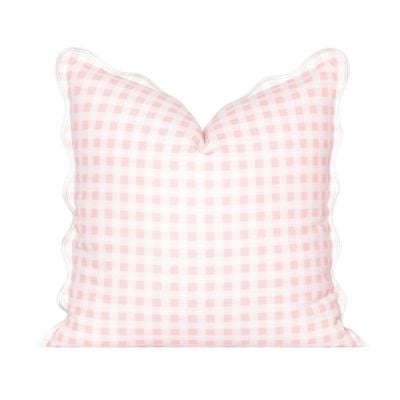 Square pillow with a pink and white gingham check pattern and scalloped edges, shown against a white background—a charming accent that gives you the Serena and Lily look for less.