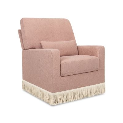 A pink upholstered armchair with a matching lumbar pillow and white fringe trim along the base, offering a chic serena and lily look for less.
