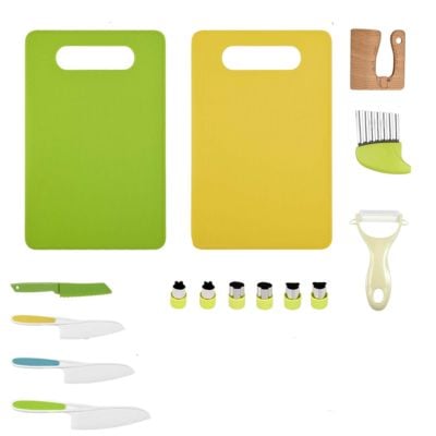 A kitchen set with two cutting boards, four knives, a vegetable peeler, a crinkle cutter, and six small round cutters, all arranged neatly on a white background.