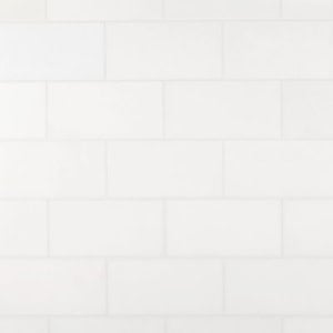 A white tiled wall with rectangular tiles arranged in a horizontal, staggered pattern.