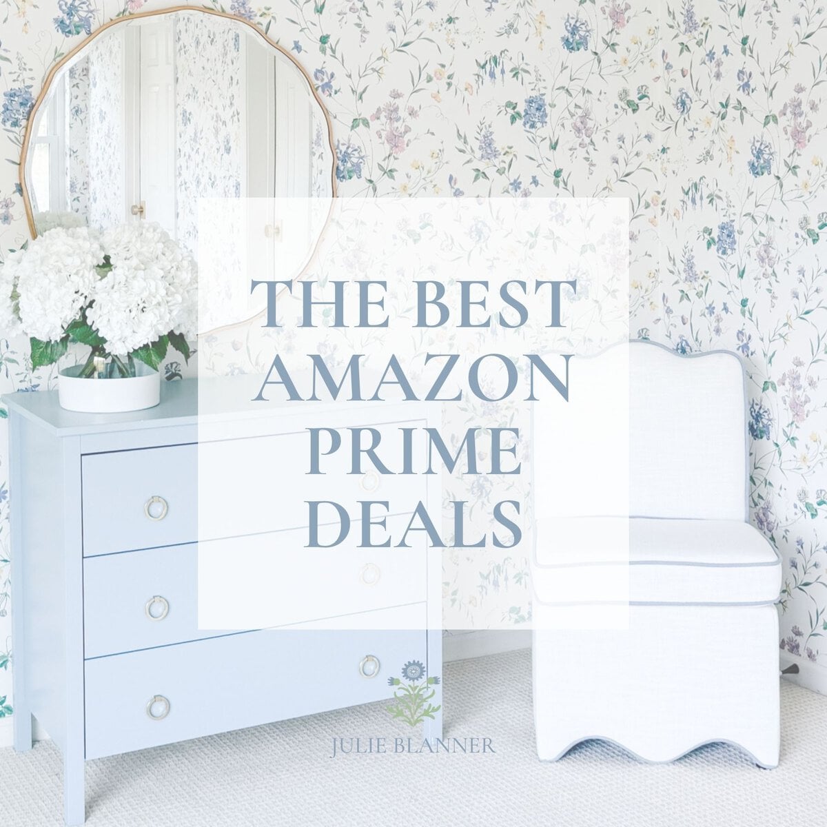 A light blue dresser with white flowers, a round mirror, and a white chair against floral wallpaper, overlaid with the text &ldquo;The Best Amazon Prime Deals.&rdquo;.