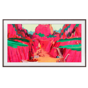 A framed painting on a Samsung Frame TV depicts a vivid landscape with bright pink cliffs, green plateaus, a sandy path, boats, and small human figures scattered throughout.