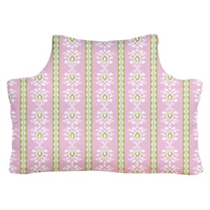 A rectangular pillow with a light pink background and white floral patterns, featuring vertical green and white striped accents.