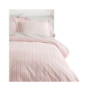 A bed with pink and white striped bedding and matching pillowcases, featuring a floral-patterned trim on the edges.