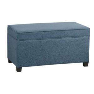 A rectangular blue upholstered storage ottoman with a hinged lid and short black legs on each corner.