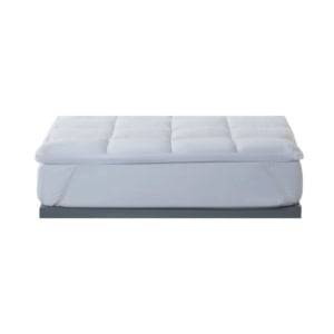 A white, rectangular mattress with a quilted top, shown on a plain platform against a white background.