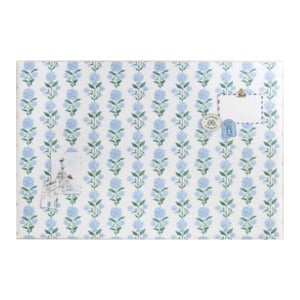 Rectangular bulletin board with blue and green floral pattern, displaying three pinned items: a postcard, a drawing, and a blue decorative card.